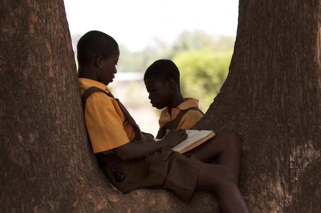 girls reading under tree in Ghana
